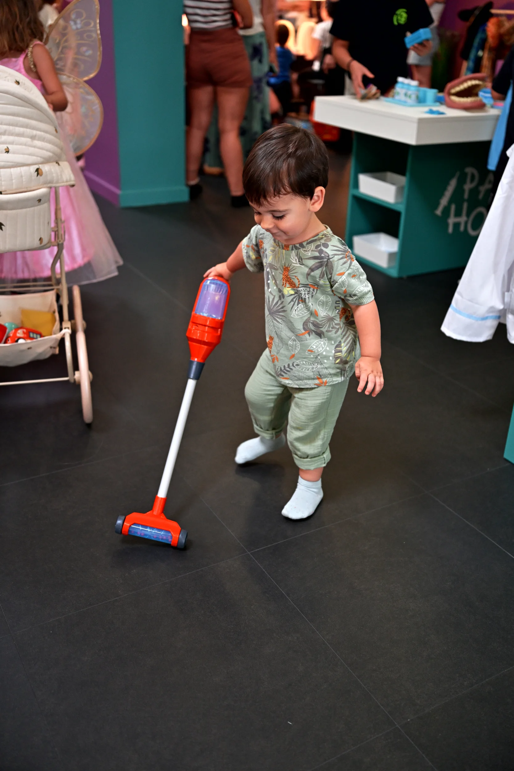 Enfant jouant avec un aspirateur miniature à Palomano Toulon